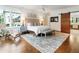 Spacious main bedroom with a sliding barn door to the bathroom and large windows overlooking the neighborhood at 123 Peachtree Cir, Atlanta, GA 30309