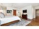 Spacious main bedroom features a sliding barn door leading to the bathroom and large dresser with a television at 123 Peachtree Cir, Atlanta, GA 30309