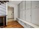 Organized mudroom with built-in storage lockers, a bench, and hardwood floors at 123 Peachtree Cir, Atlanta, GA 30309