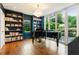 Sophisticated home office with custom bookshelves, a grand piano, and natural light at 123 Peachtree Cir, Atlanta, GA 30309