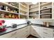 This butler's pantry features a gray counter, mixer, toaster, coffee maker, and open shelving for storage at 123 Peachtree Cir, Atlanta, GA 30309