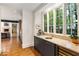 This wet bar includes a sink, wine cooler, storage cabinets, and a large window with backyard view at 123 Peachtree Cir, Atlanta, GA 30309