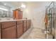 Bathroom features a double sink vanity with granite countertop, custom cabinets, and tile flooring at 15 Masters Dr, Villa Rica, GA 30180