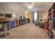 Spacious carpeted bedroom featuring a ceiling fan, built-in shelving, and a comfortable seating area at 15 Masters Dr, Villa Rica, GA 30180