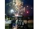 People enjoying a fireworks show over a golf cart with an American flag at 15 Masters Dr, Villa Rica, GA 30180