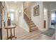 Inviting entryway with wood-look floors and staircase leading upstairs, enhanced by neutral walls and natural light at 15 Masters Dr, Villa Rica, GA 30180