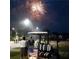 Residents enjoy fireworks at night with a golf cart decorated with American flags at 15 Masters Dr, Villa Rica, GA 30180