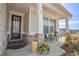 Inviting covered porch featuring brick accents, a seating area with chairs and small table, and a decorative door at 15 Masters Dr, Villa Rica, GA 30180