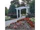 Beautiful community gardens with colorful flowers and a white pergola at 15 Masters Dr, Villa Rica, GA 30180