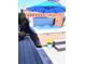 Private hot tub area with a blue umbrella and nearby seating, nestled in a cozy outdoor space at 15 Masters Dr, Villa Rica, GA 30180