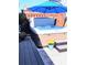 Outdoor hot tub with a blue umbrella provides relaxation and fun, and includes steps for easy access at 15 Masters Dr, Villa Rica, GA 30180