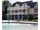 A community pool with a two story clubhouse with seating at 15 Masters Dr, Villa Rica, GA 30180