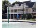 Community pool with beach chairs and a water feature on a sunny day at 15 Masters Dr, Villa Rica, GA 30180