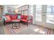 Relaxing sunroom with comfortable seating, colorful pillows, and natural light streaming through large windows at 15 Masters Dr, Villa Rica, GA 30180