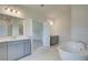 Elegant primary bathroom featuring double vanities and a luxurious standalone soaking tub at 21 Homesite Cooper E Cv, Fayetteville, GA 30215
