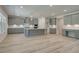 Modern kitchen with gray cabinets, a large island, and stainless steel appliances at 21 Homesite Cooper E Cv, Fayetteville, GA 30215