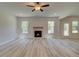 Bright living room with fireplace and natural light from large windows at 21 Homesite Cooper E Cv, Fayetteville, GA 30215