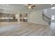 Open living area with a staircase and a modern kitchen in the background at 21 Homesite Cooper E Cv, Fayetteville, GA 30215