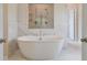 Luxurious main bathroom features a freestanding tub, a glass-enclosed shower, and marble-look tile at 21 Homesite Cooper E Cv, Fayetteville, GA 30215