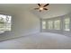 Spacious main bedroom with neutral carpet, ample windows, and ceiling fan at 21 Homesite Cooper E Cv, Fayetteville, GA 30215