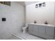 Bathroom featuring gray vanity, white tile, dual sinks, and modern lighting at 2191 Camp Ground Rd, Atlanta, GA 30331