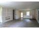 Open concept living room with grey flooring, featuring an unfinished fireplace at 2191 Camp Ground Rd, Atlanta, GA 30331