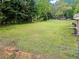 Fenced backyard featuring a well-maintained lawn and mature trees, creating a private outdoor space at 2310 Rubart Dr, Marietta, GA 30066