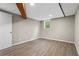 Bright basement room with wood flooring, beam, and a window offering natural light at 2310 Rubart Dr, Marietta, GA 30066