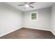 Neutral colored bedroom featuring hardwood floors, ceiling fan, and a window at 2310 Rubart Dr, Marietta, GA 30066