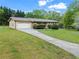 Well-maintained one-story home with a two-car garage and a long driveway extending to the house at 2310 Rubart Dr, Marietta, GA 30066