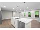 Bright kitchen with white cabinets, stainless steel appliances, an island sink, and hardwood floors throughout at 2310 Rubart Dr, Marietta, GA 30066