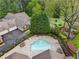 Aerial view showcasing a pool and a home surrounded by lush greenery at 3344 Timbersedge Dr # 5, Marietta, GA 30064