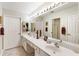 Bright bathroom featuring double sinks and vanities with neutral colored tiling and trim at 3344 Timbersedge Dr # 5, Marietta, GA 30064