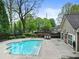 Community pool and clubhouse surrounded by green trees and bushes at 3344 Timbersedge Dr # 5, Marietta, GA 30064