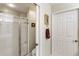 Shower with white tiling, glass doors, towel rack and neutral colored walls at 3344 Timbersedge Dr # 5, Marietta, GA 30064