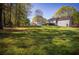 Expansive backyard featuring a lush lawn and mature trees, perfect for outdoor enjoyment at 670 Maplelake Dr, Acworth, GA 30101