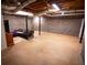 Spacious unfinished basement with block walls ready for customization, with a sofa at 670 Maplelake Dr, Acworth, GA 30101