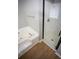 Bright bathroom features a glass enclosed shower and a soaking tub on hardwood floors at 670 Maplelake Dr, Acworth, GA 30101