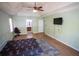 Spacious bedroom featuring wood floors, a ceiling fan, and an open doorway to an attached bathroom at 670 Maplelake Dr, Acworth, GA 30101