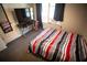 Comfortable bedroom with striped bed, window with curtains, TV, and neutral decor at 670 Maplelake Dr, Acworth, GA 30101