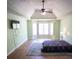 Large Primary bedroom boasts ample space, a ceiling fan, and lots of natural light from the bay window at 670 Maplelake Dr, Acworth, GA 30101