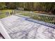 Spacious gray wooden deck offers serene views of the backyard and surrounding greenery at 670 Maplelake Dr, Acworth, GA 30101