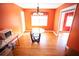 Bright dining room with a chandelier and orange walls and hardwood floors at 670 Maplelake Dr, Acworth, GA 30101
