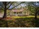 Charming single-story home featuring a welcoming front porch with white railings, and a well-maintained lawn at 670 Maplelake Dr, Acworth, GA 30101