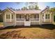 Inviting single-story home boasts a cozy front porch, large windows, and a well-manicured lawn at 670 Maplelake Dr, Acworth, GA 30101