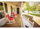 Inviting front porch with two red rocking chairs and ceiling fan offering a relaxing outdoor space at 670 Maplelake Dr, Acworth, GA 30101
