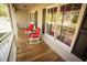Cozy front porch with classic white railings, featuring two inviting rocking chairs and ample natural light at 670 Maplelake Dr, Acworth, GA 30101