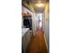 Long hallway featuring hardwood floors and a laundry closet with washer and dryer at 670 Maplelake Dr, Acworth, GA 30101