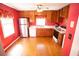 Well-lit kitchen with wooden cabinets, hardwood floor, and stainless steel refrigerator at 670 Maplelake Dr, Acworth, GA 30101