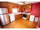Well-lit kitchen with wooden cabinets, hardwood floor, and stainless steel refrigerator at 670 Maplelake Dr, Acworth, GA 30101